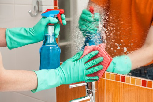 Cleaner carrying out a safe professional cleaning task in Watford