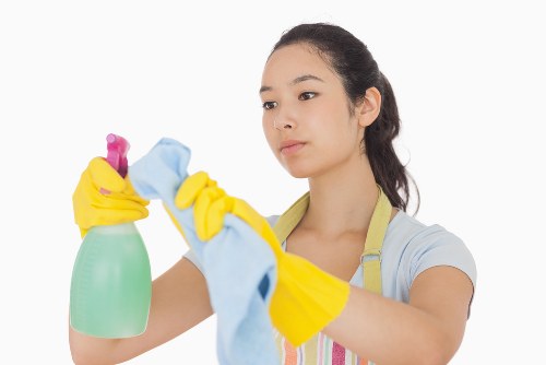 Professional home cleaner vacuuming a modern Watford house